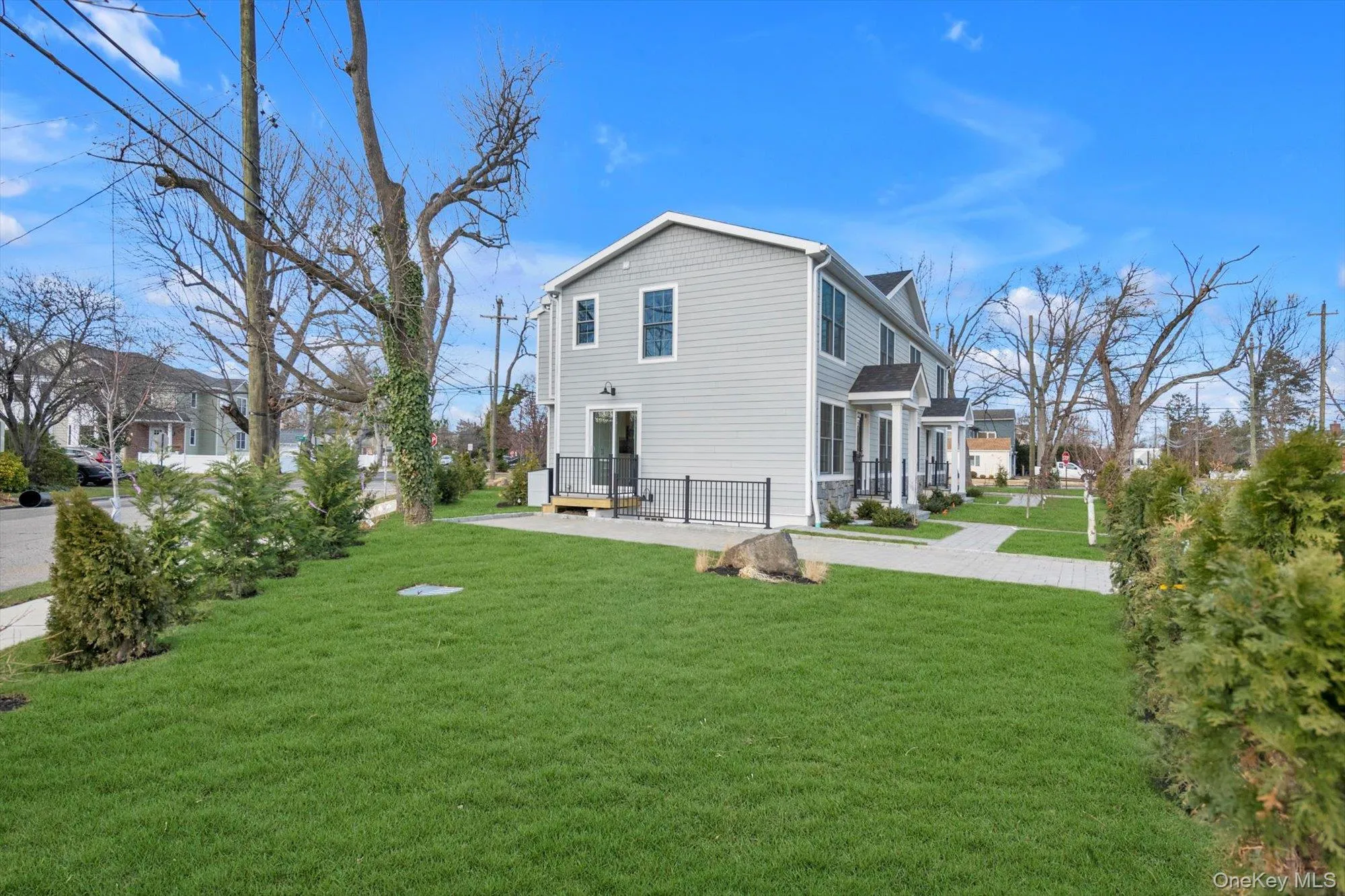 View of side of property featuring a yard and a patio View of side of property featuring a yard and a patio