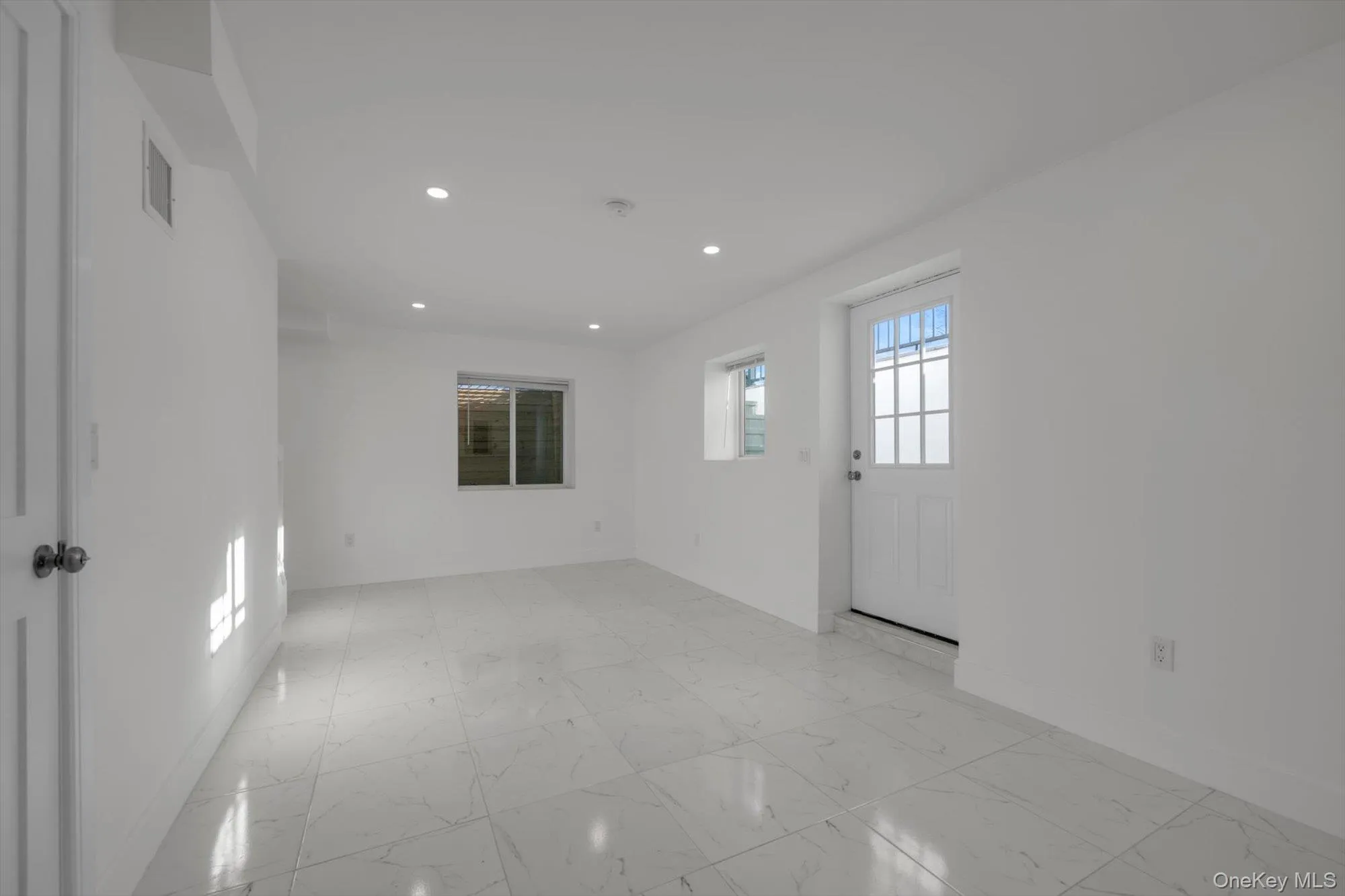 Spare room with light marble finish flooring and recessed lighting Spare room with light marble finish flooring and recessed lighting