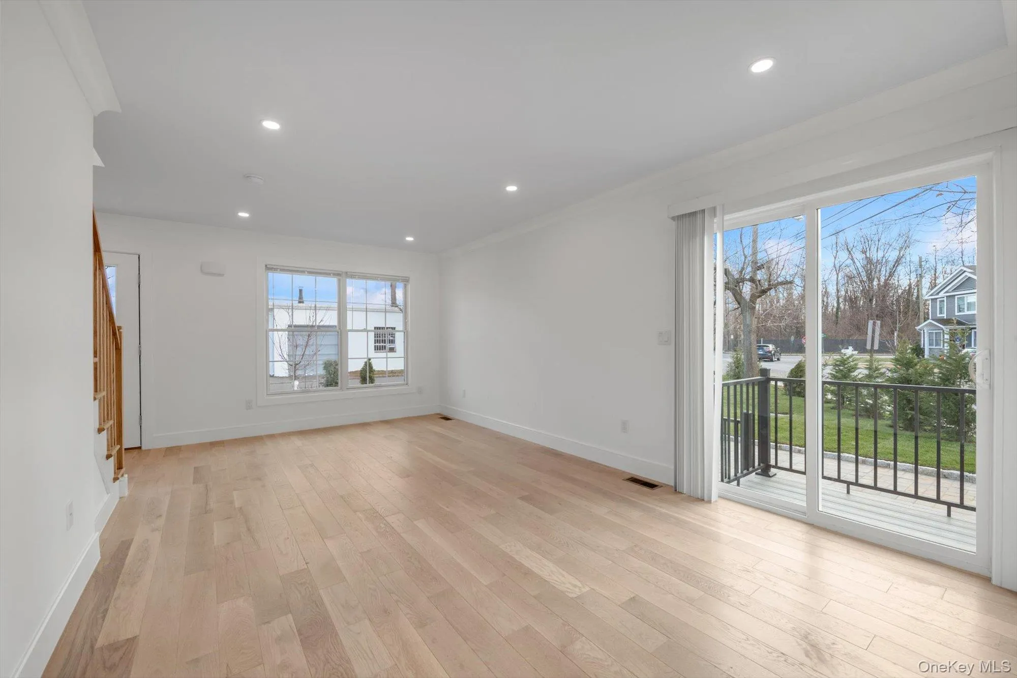 Spare room featuring light wood-style flooring, recessed lighting, stairway, and ornamental molding Spare room featuring light wood-style flooring, recessed lighting, stairway, and ornamental molding