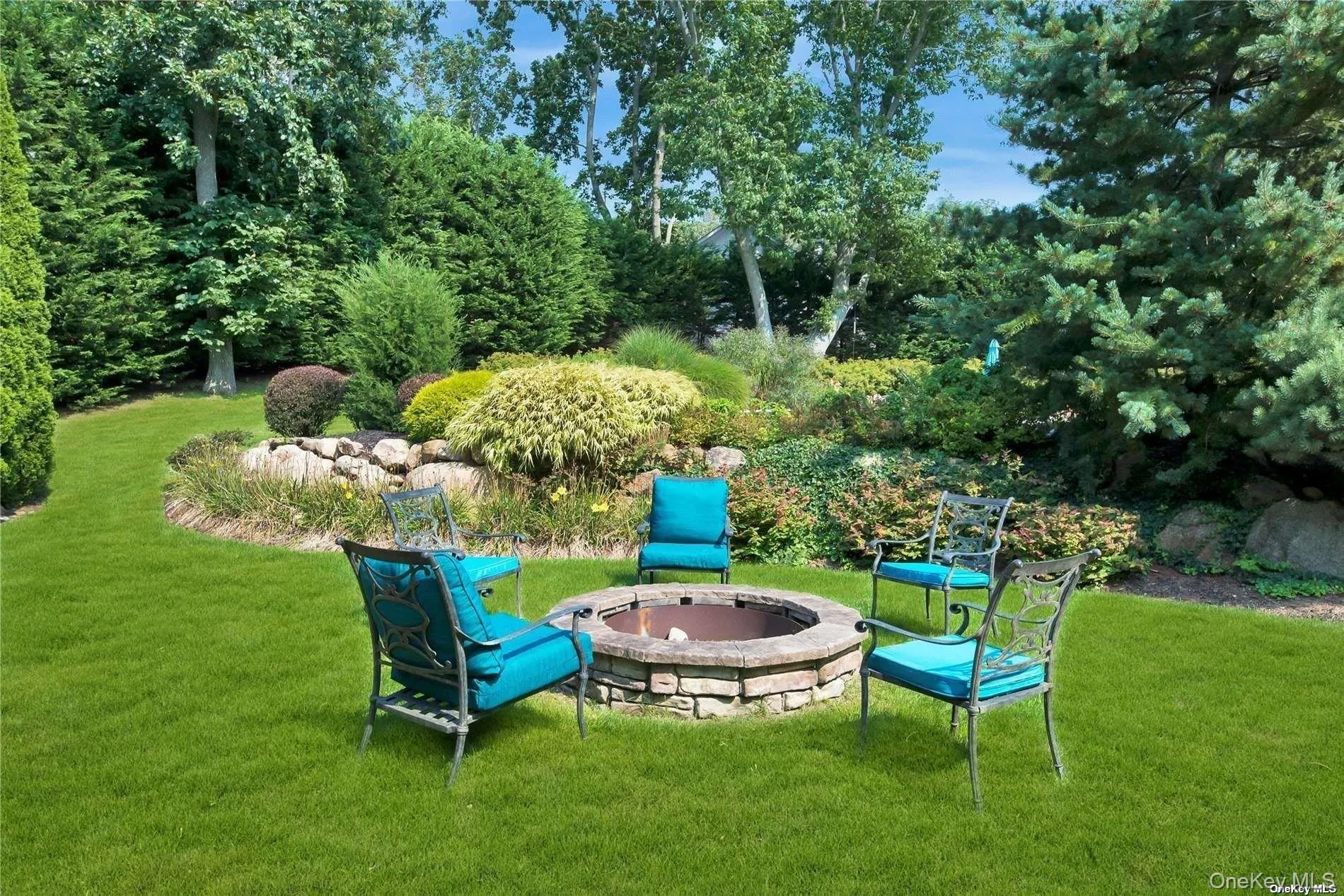 Manicured gardens, Fire pit, tree swing in the distance Manicured gardens, Fire pit, tree swing in the distance