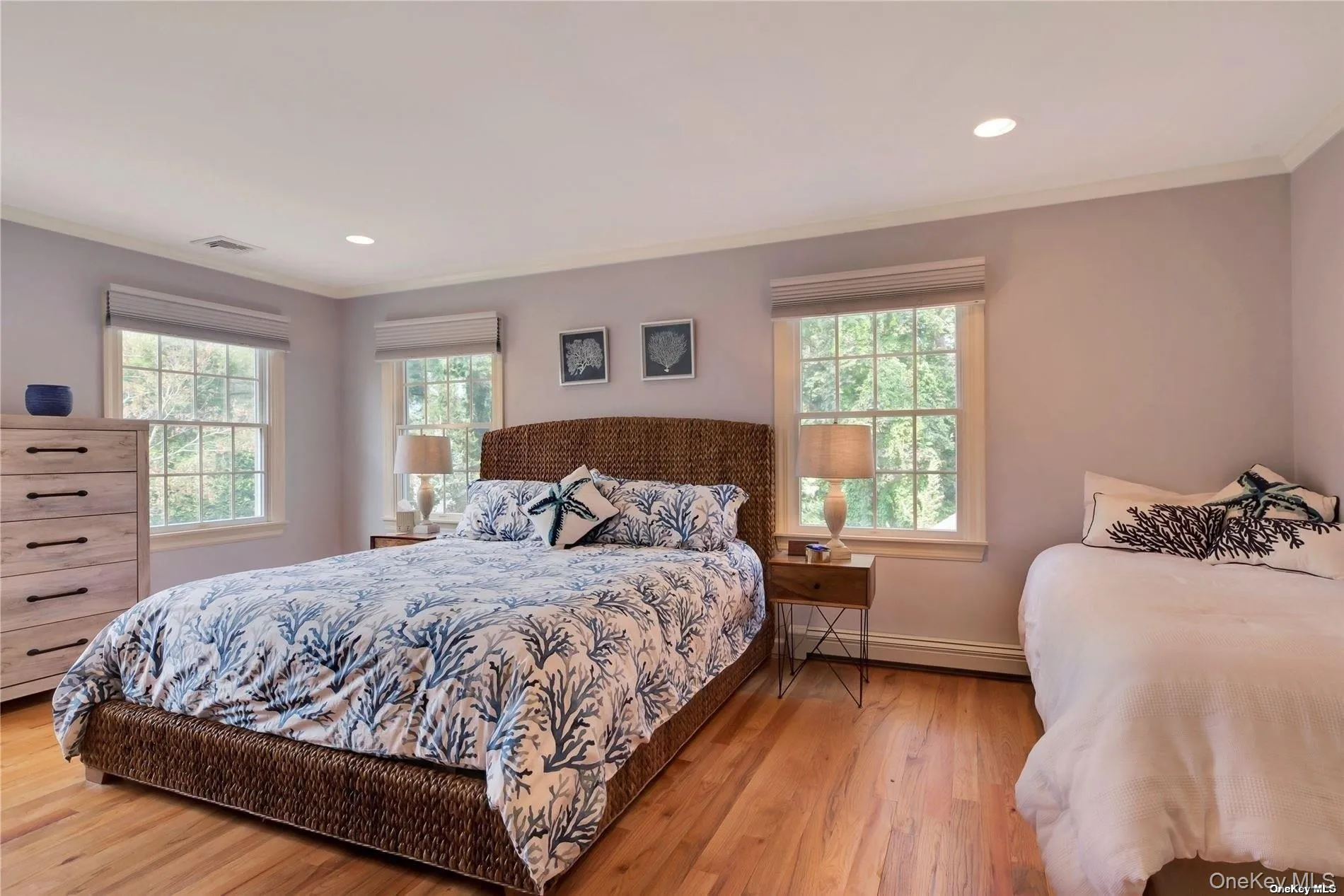 Primary bedroom with California king bed and twin bed and twin trundle bed Primary bedroom with California king bed and twin bed and twin trundle bed
