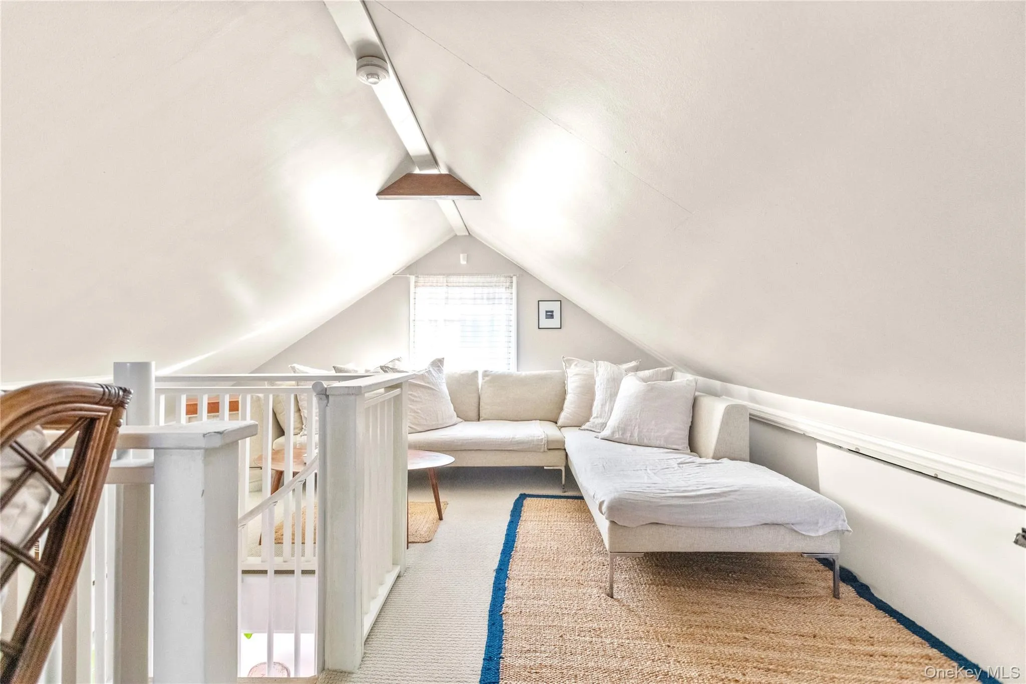 Bedroom featuring light carpet and lofted ceiling Bedroom featuring light carpet and lofted ceiling