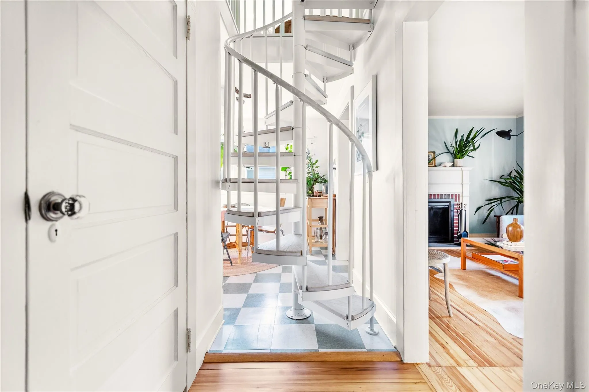 Foyer featuring a brick fireplace and light flooring Foyer featuring a brick fireplace and light flooring