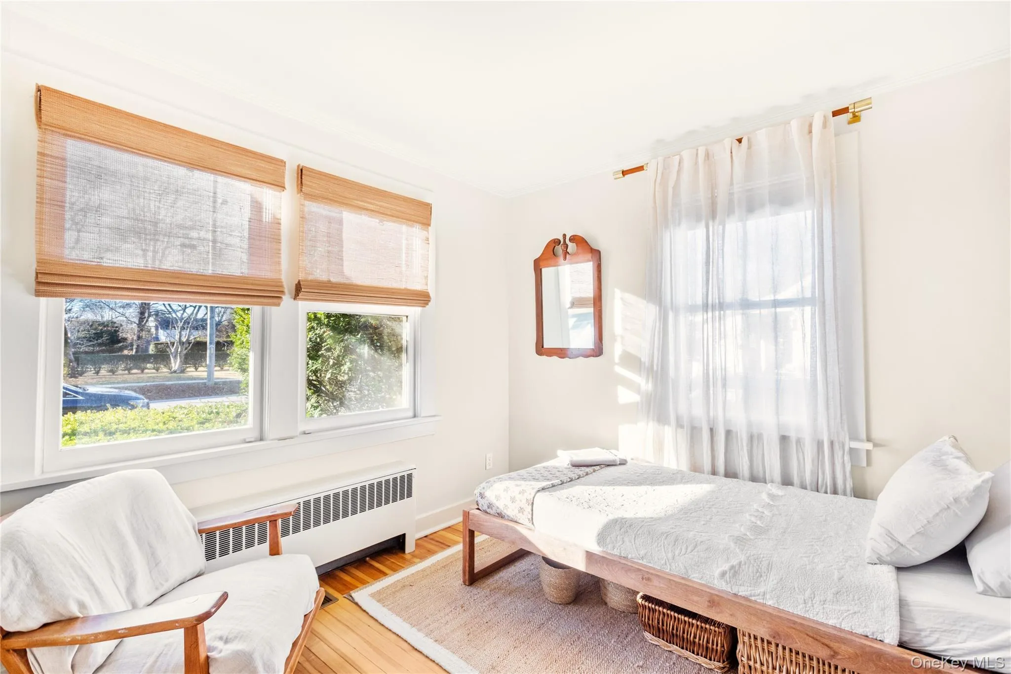 Bedroom featuring radiator and wood-type flooring Bedroom featuring radiator and wood-type flooring