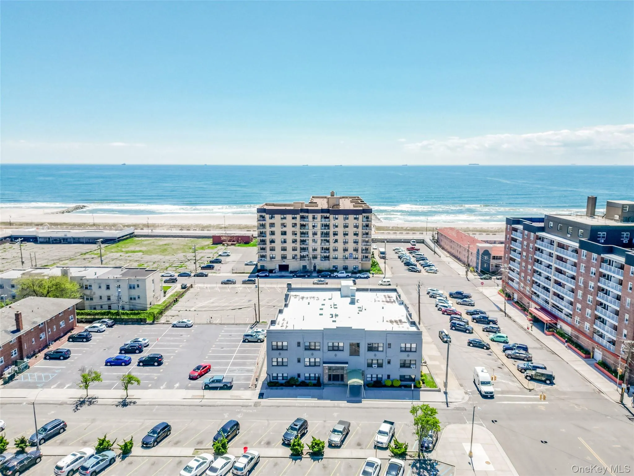 Bird's eye view of a nearby body of water and apartment complex Bird's eye view of a nearby body of water and apartment complex