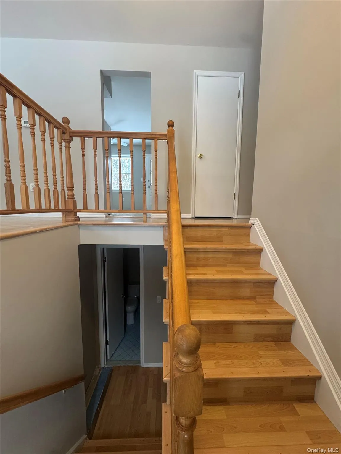 Staircase featuring wood finished floors and baseboards Staircase featuring wood finished floors and baseboards