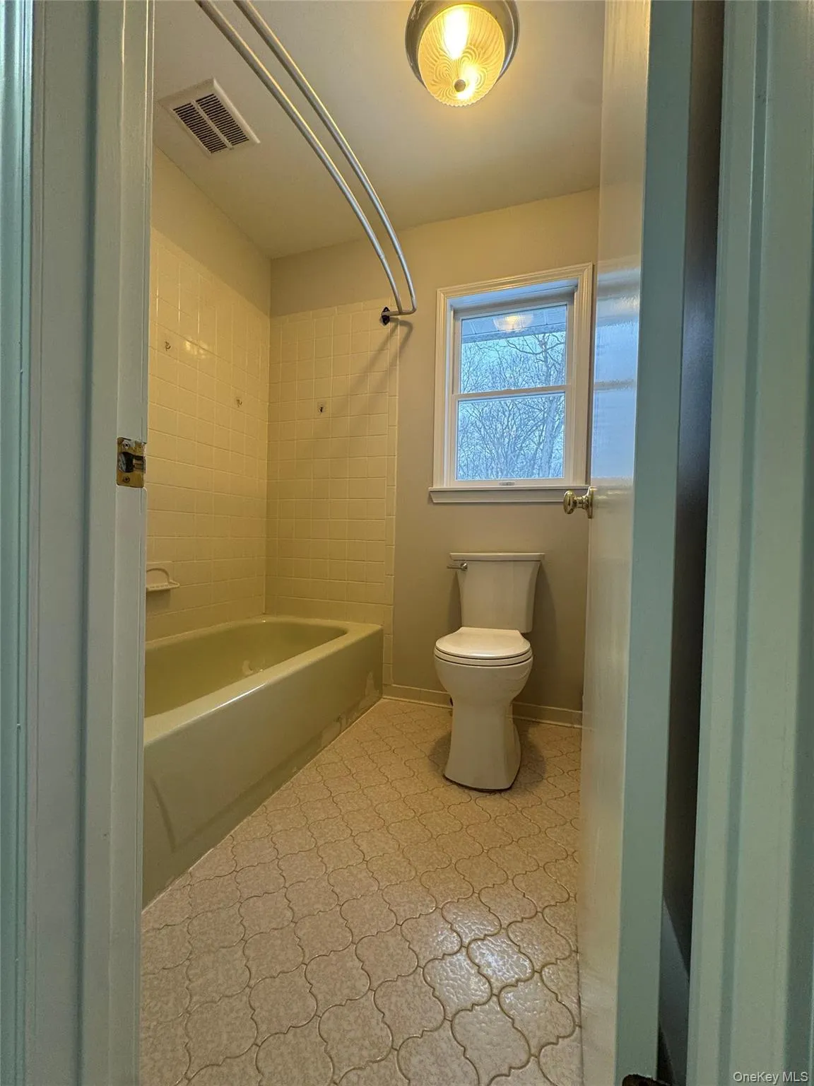 Full bathroom with bathtub / shower combination and toilet Full bathroom with bathtub / shower combination and toilet