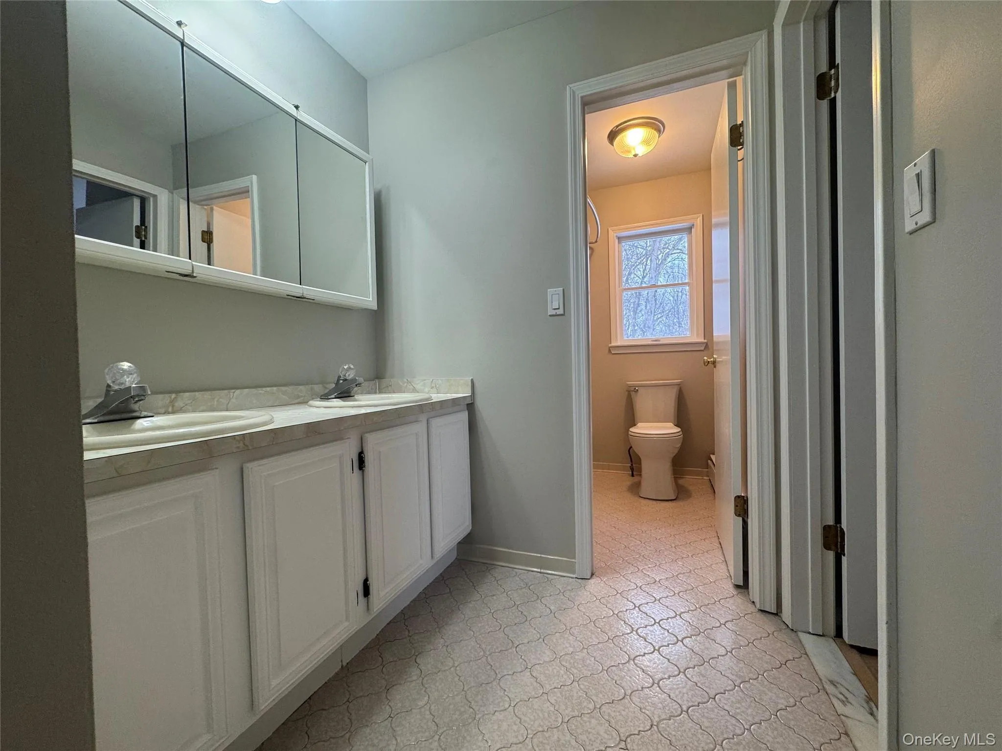 Full bath featuring double vanity and light floors Full bath featuring double vanity and light floors