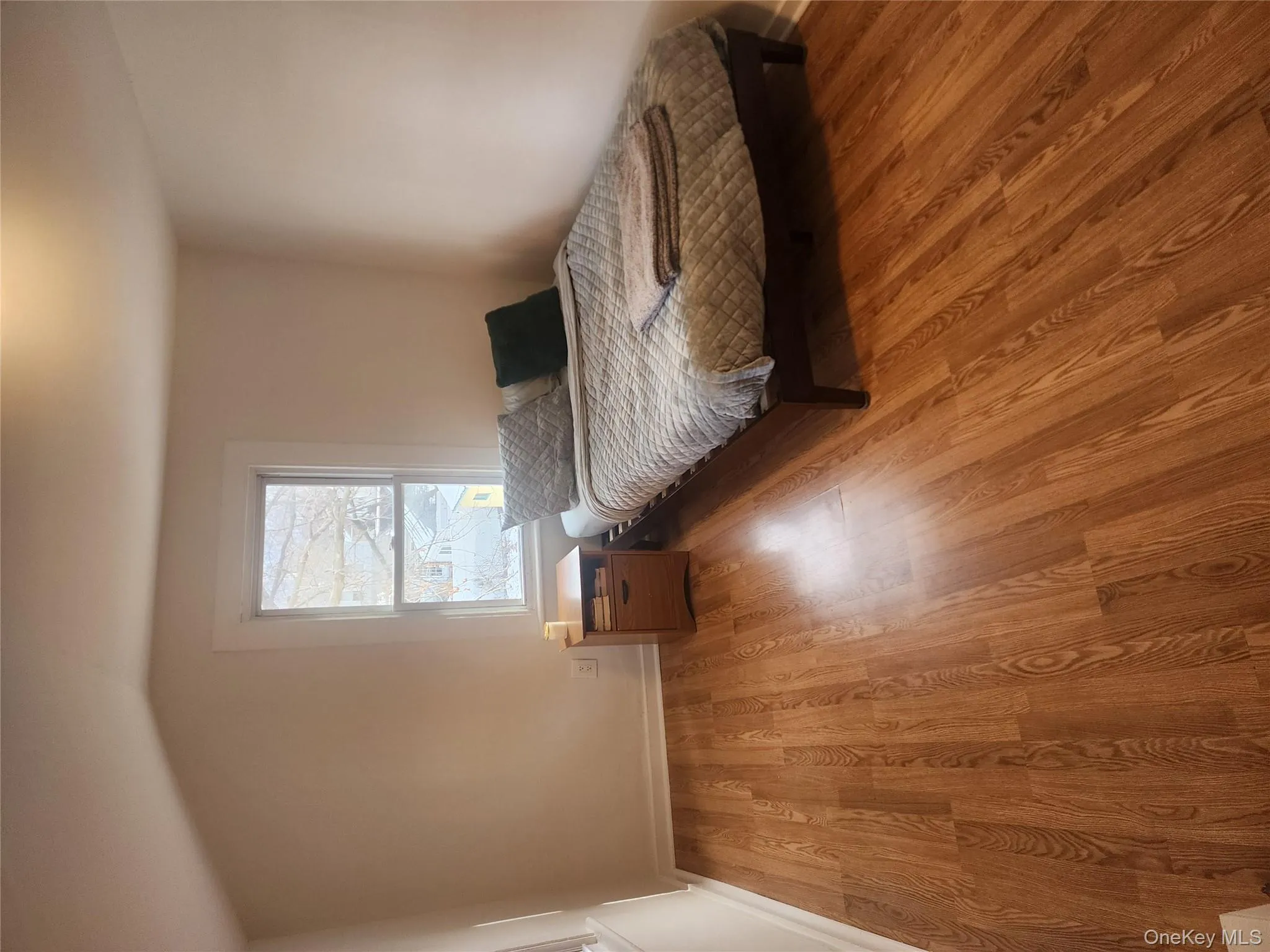 Bedroom with light wood-style flooring and vaulted ceiling Bedroom with light wood-style flooring and vaulted ceiling