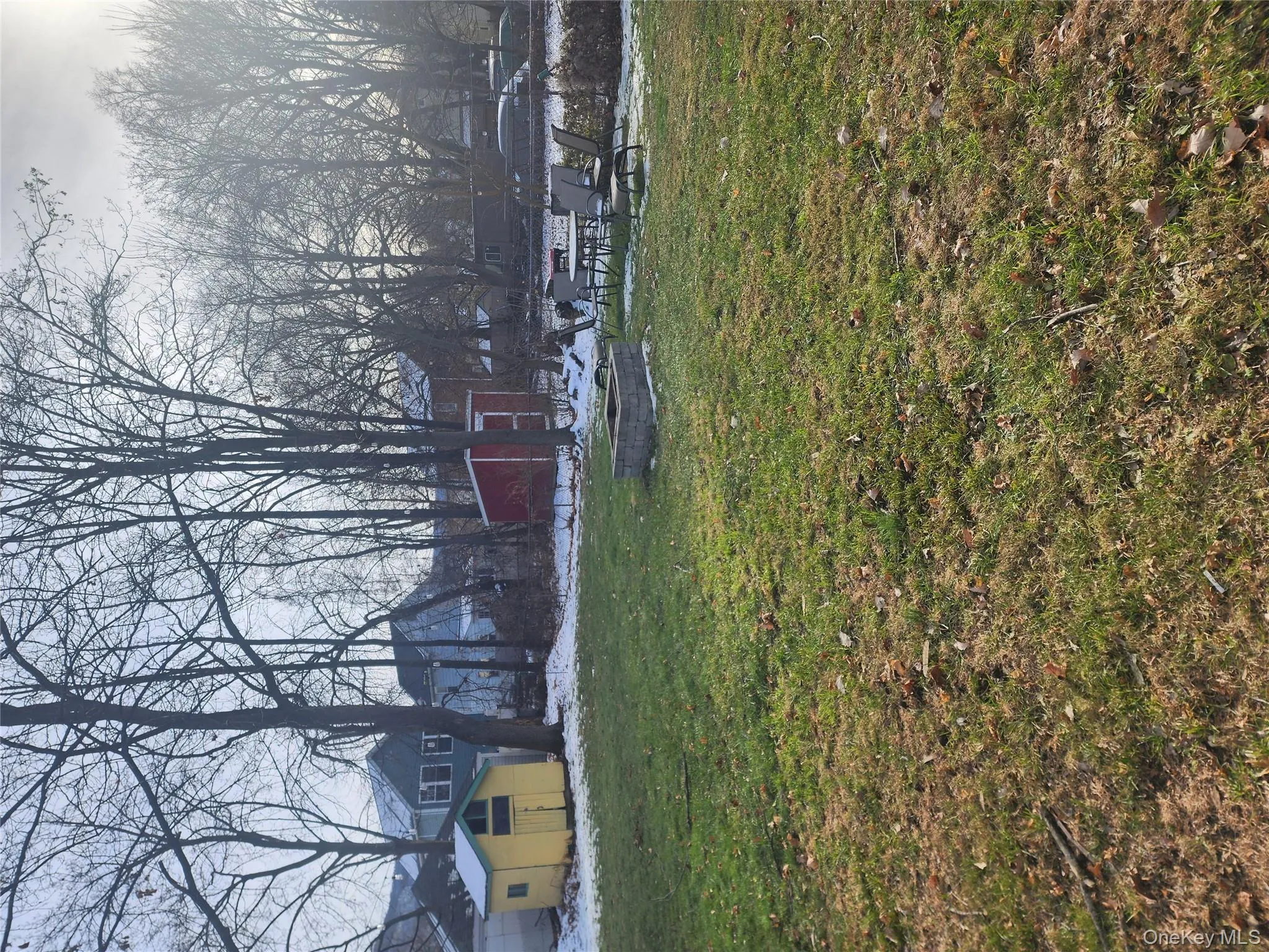 View of green lawn with a shed and a patio View of green lawn with a shed and a patio