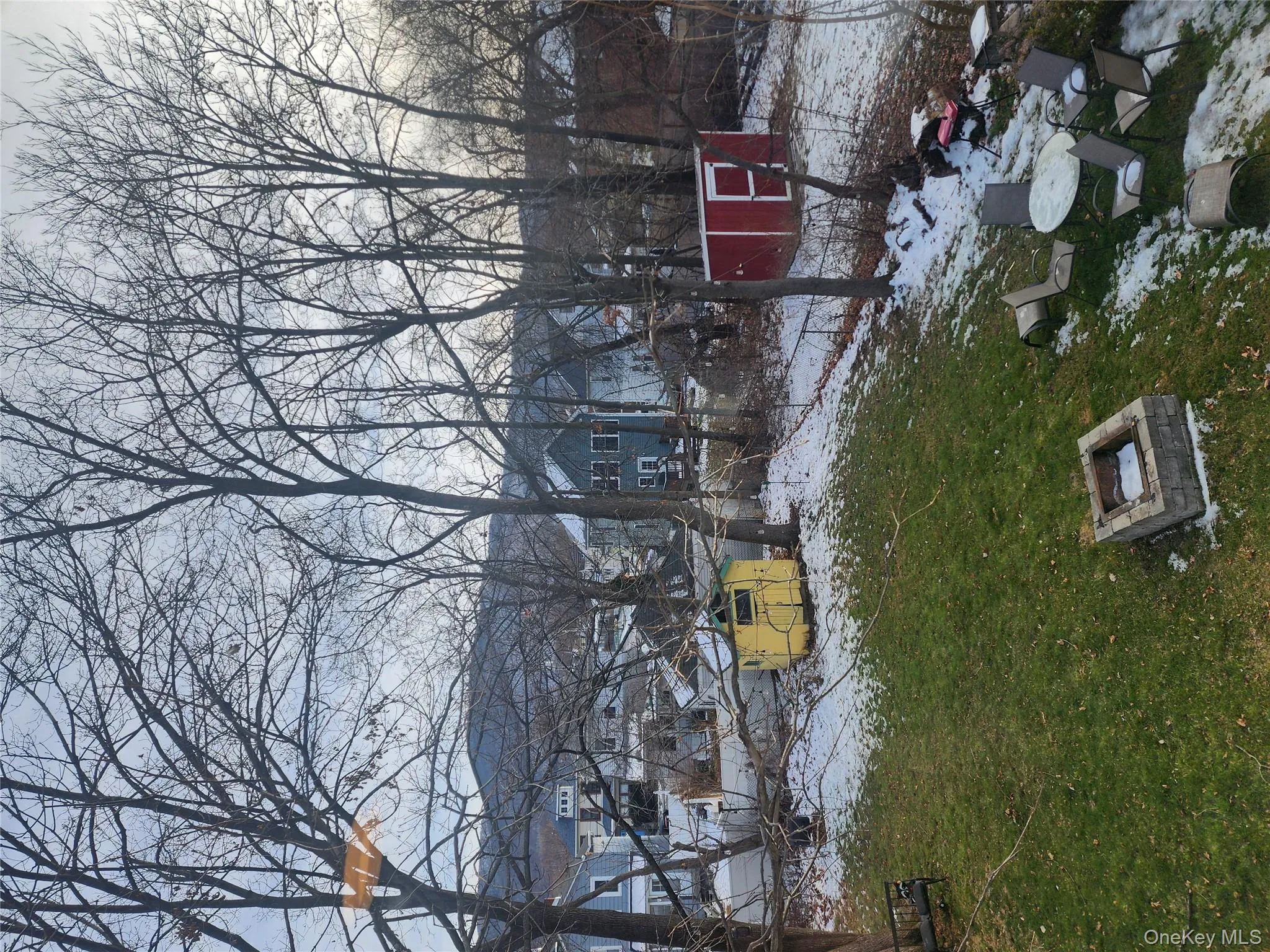 Yard covered in snow featuring a lawn and a residential view Yard covered in snow featuring a lawn and a residential view