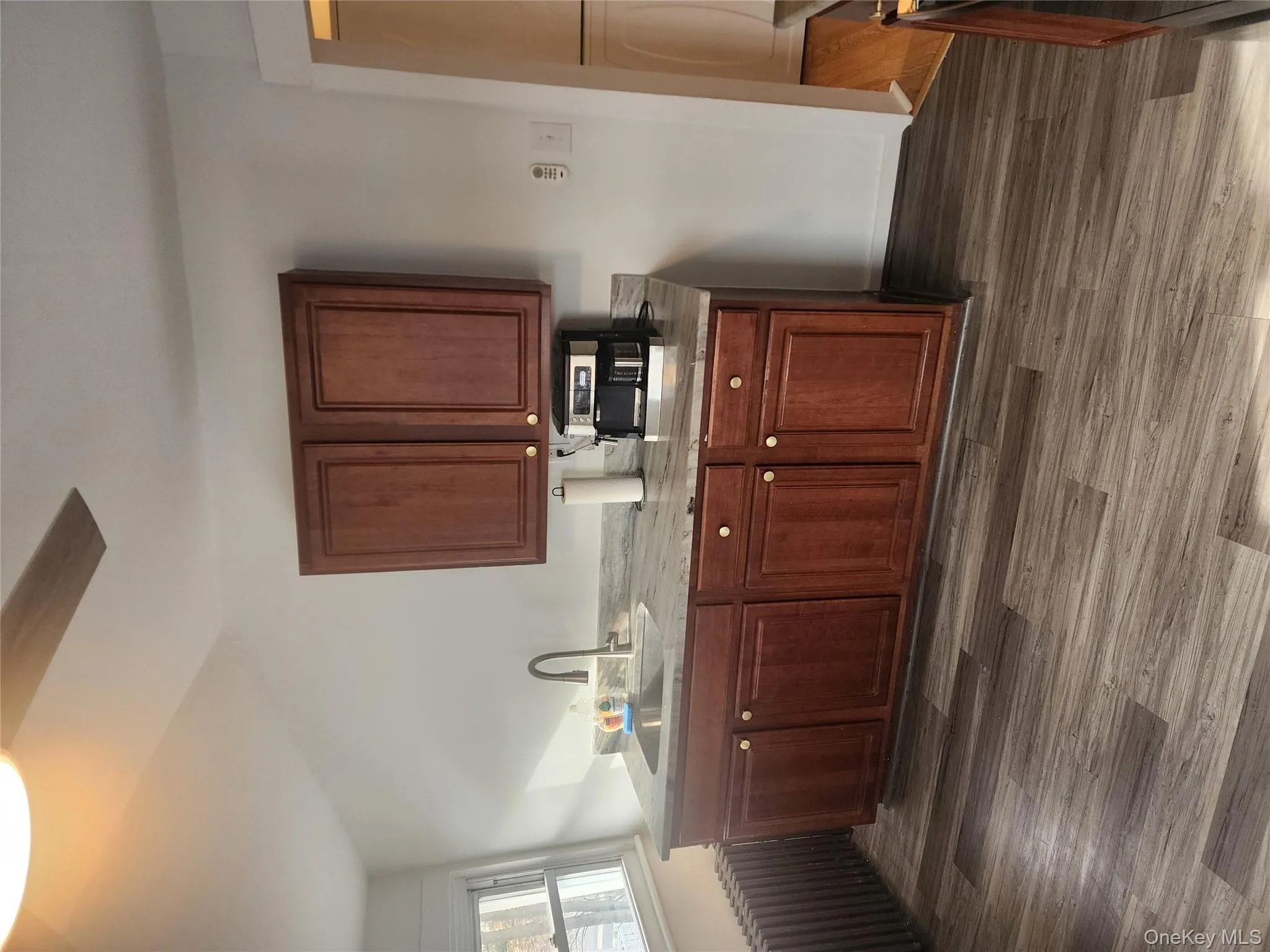 Kitchen with radiator heating unit, dark wood finished floors, and a ceiling fan Kitchen with radiator heating unit, dark wood finished floors, and a ceiling fan