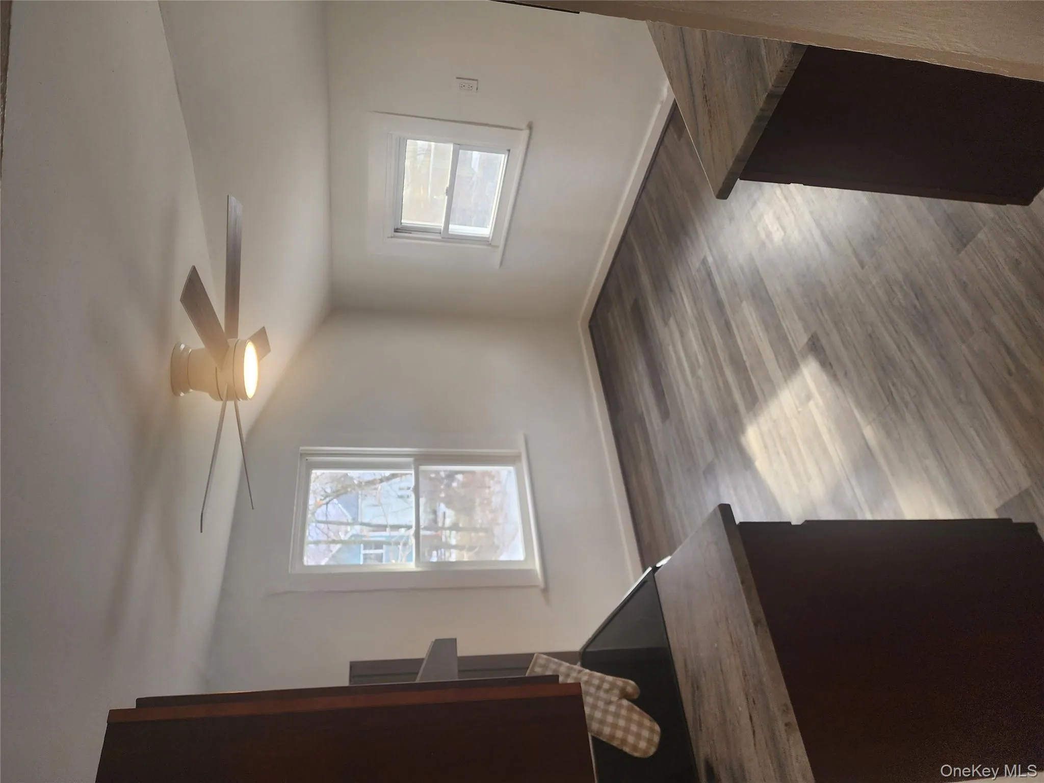 Unfurnished dining area featuring vaulted ceiling, dark wood-style floors, and a ceiling fan Unfurnished dining area featuring vaulted ceiling, dark wood-style floors, and a ceiling fan