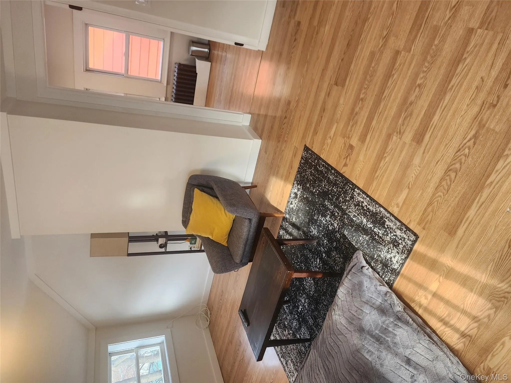 Living area with light wood-style flooring and crown molding Living area with light wood-style flooring and crown molding