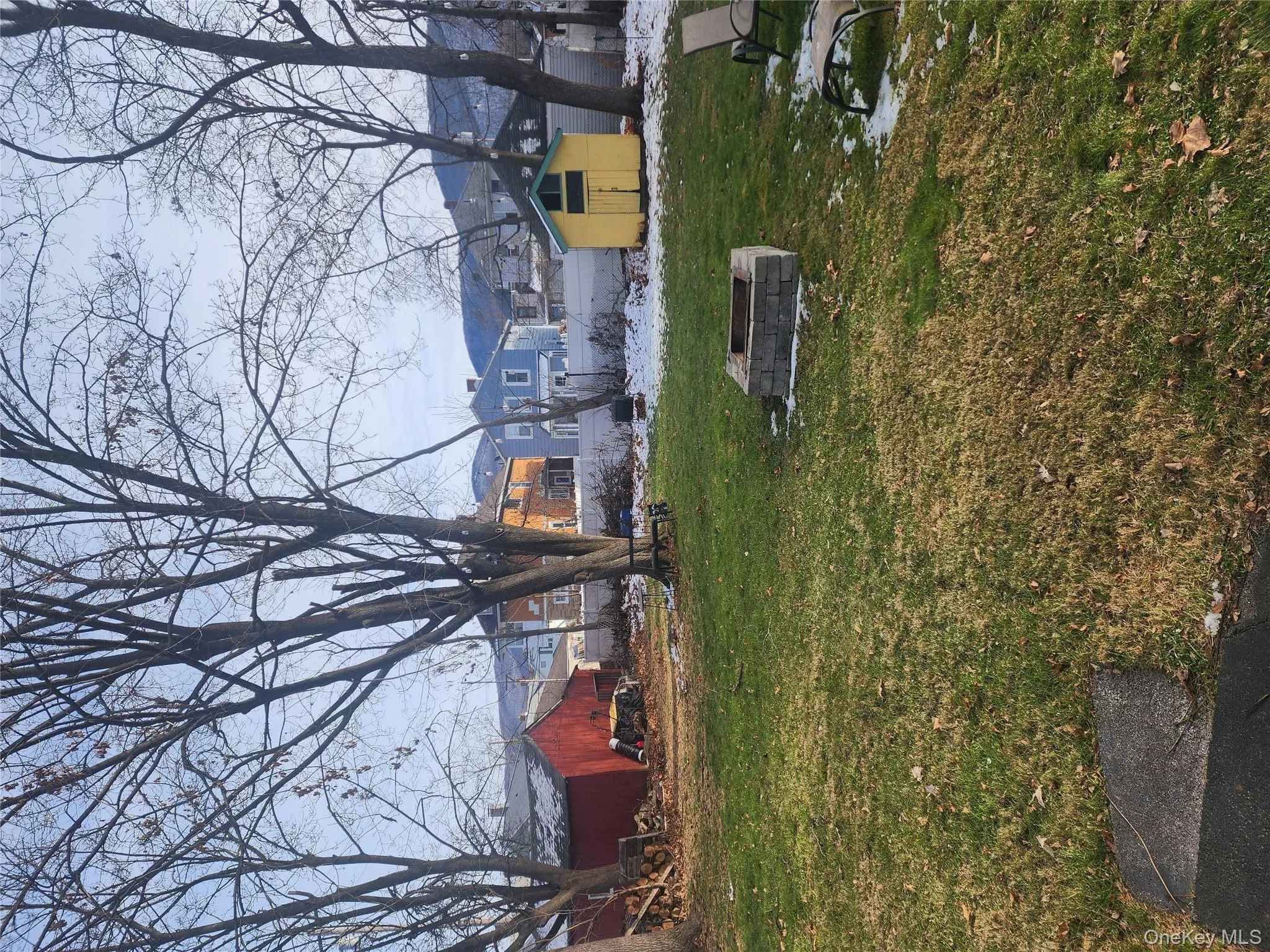 View of grassy yard featuring a storage shed and a fire pit View of grassy yard featuring a storage shed and a fire pit