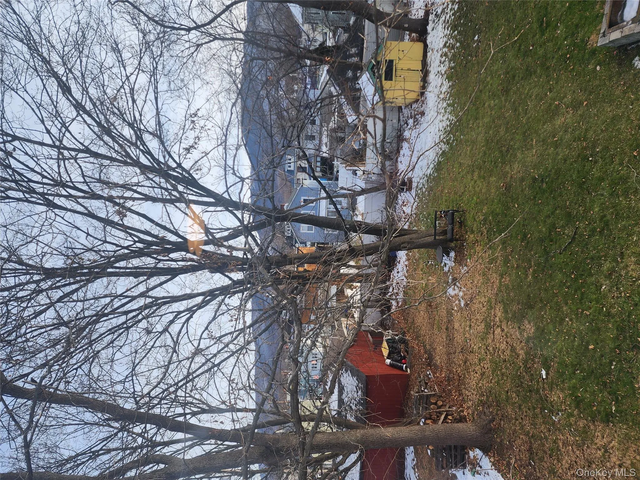 Yard covered in snow with an outbuilding and a lawn Yard covered in snow with an outbuilding and a lawn