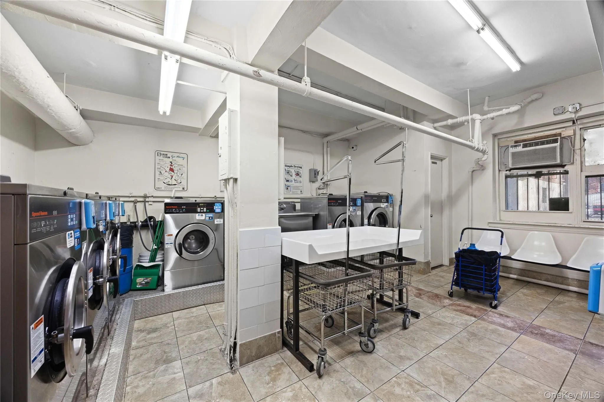 Shared laundry room featuring independent washer and dryer and baseboard heating Shared laundry room featuring independent washer and dryer and baseboard heating