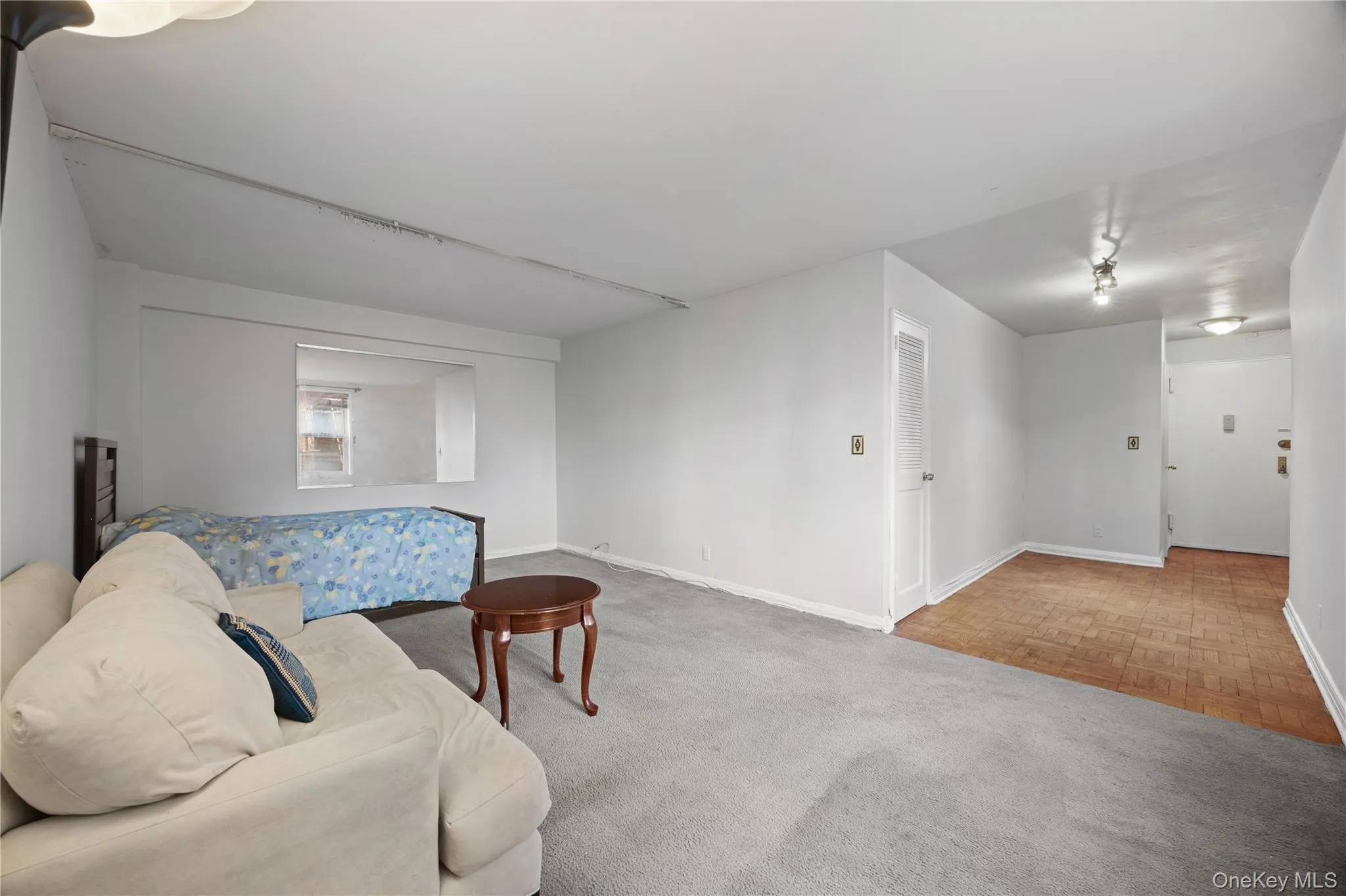 Sitting room with light colored carpet and baseboards Sitting room with light colored carpet and baseboards