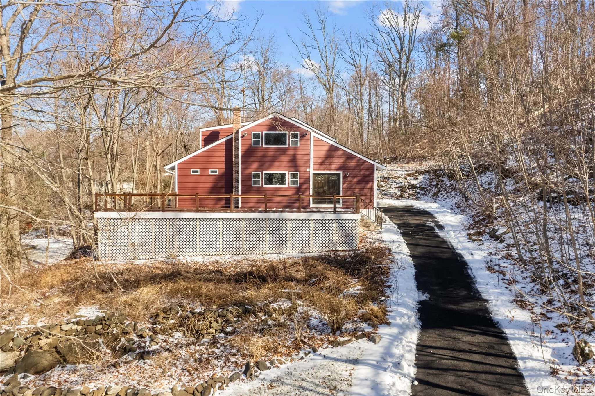 View of snow covered exterior featuring a deck View of snow covered exterior featuring a deck
