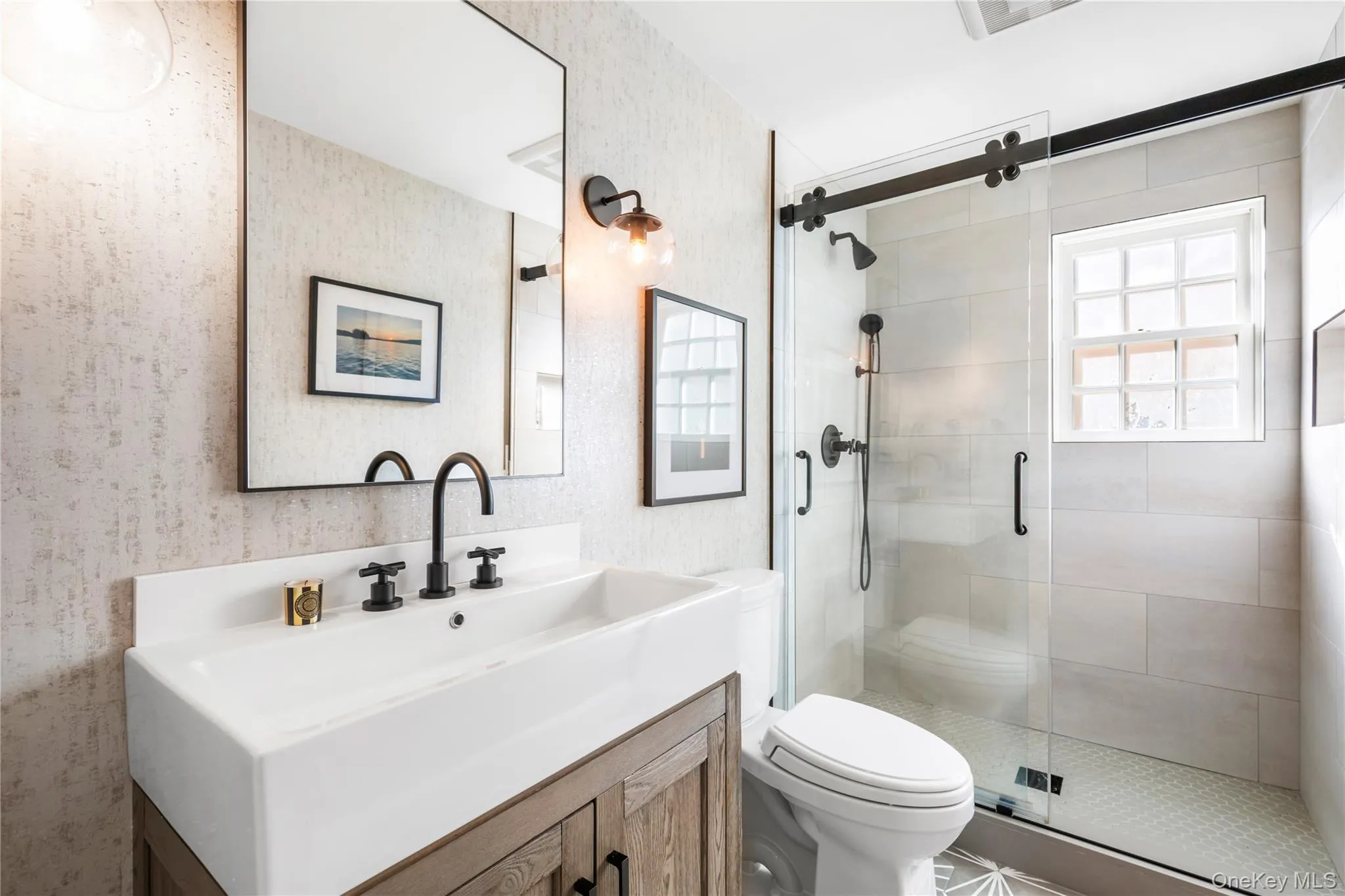 First floor full bathroom featuring vanity, a shower stall, and wallpapered walls First floor full bathroom featuring vanity, a shower stall, and wallpapered walls