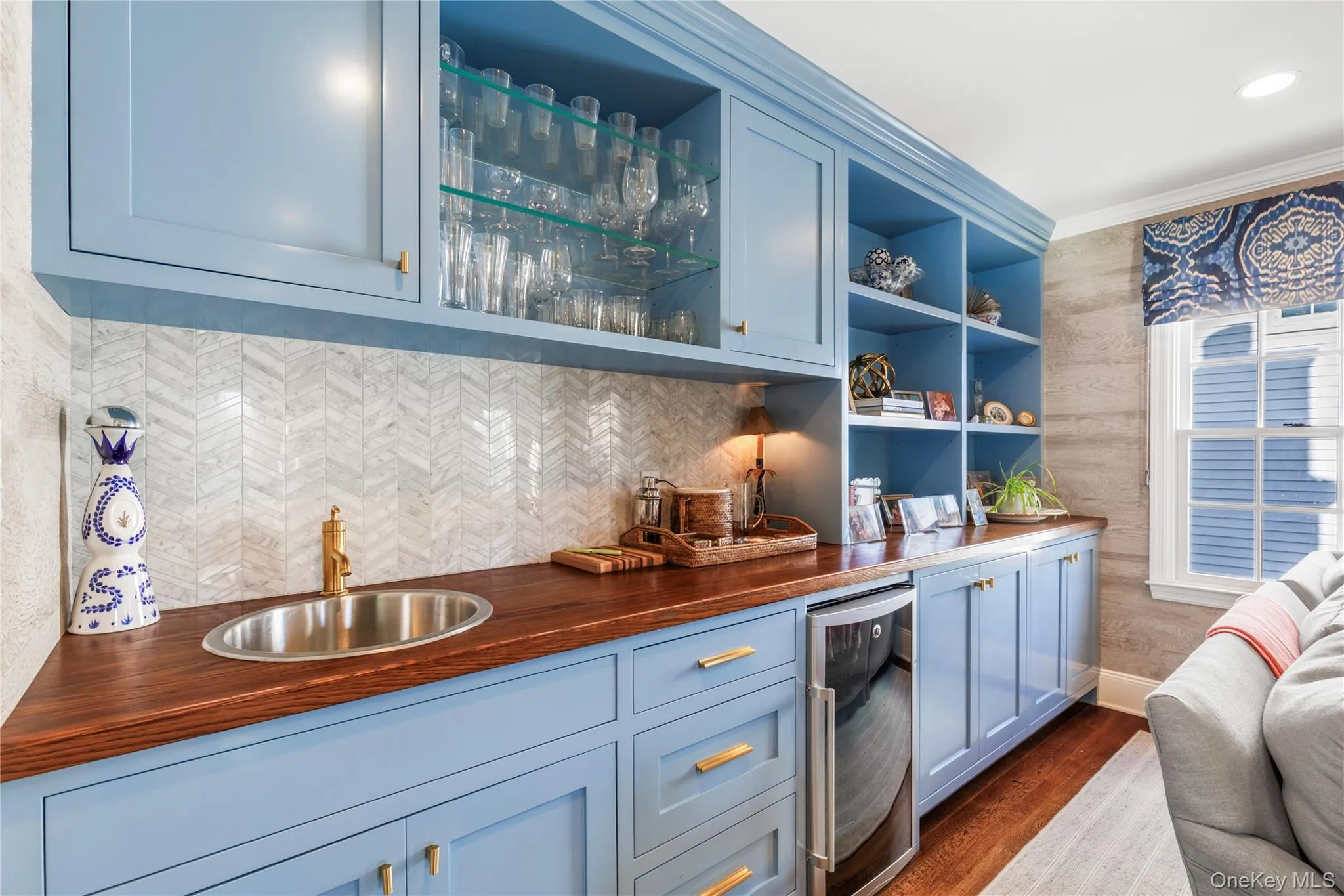 Indoor wet bar featuring butcher block countertops, open shelves, wine cooler, dark wood-style flooring, and decorative backsplash Indoor wet bar featuring butcher block countertops, open shelves, wine cooler, dark wood-style flooring, and decorative backsplash