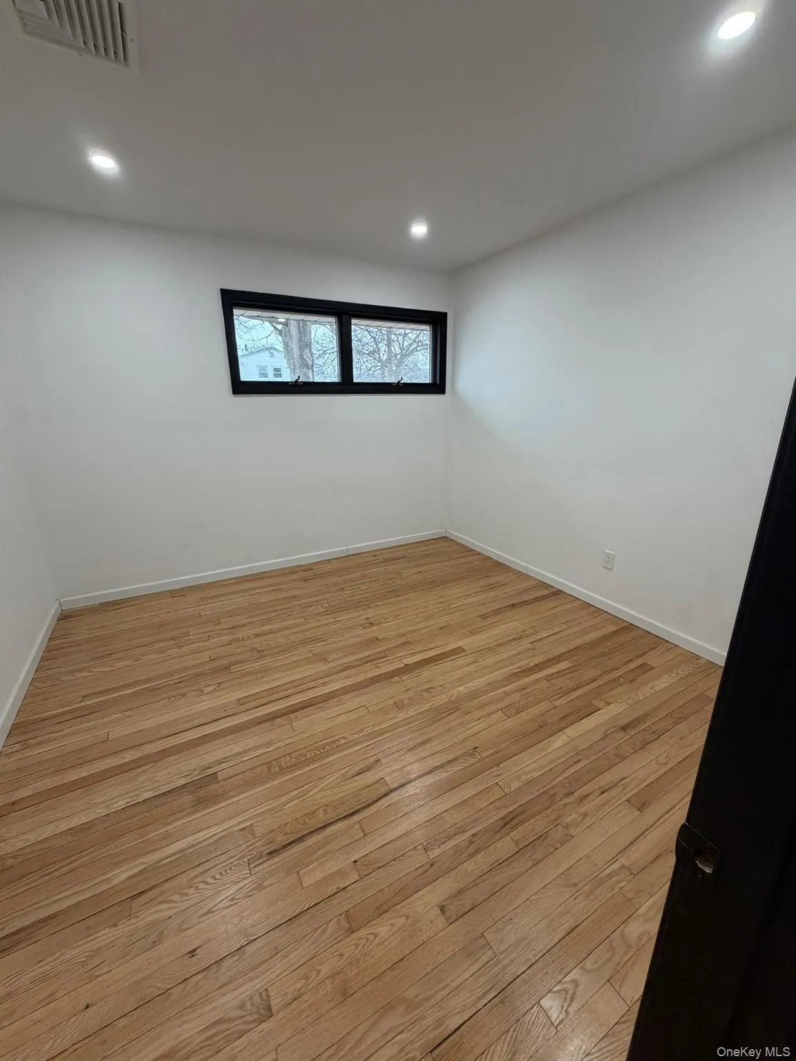 Spare room featuring recessed lighting and light wood-style floors Spare room featuring recessed lighting and light wood-style floors