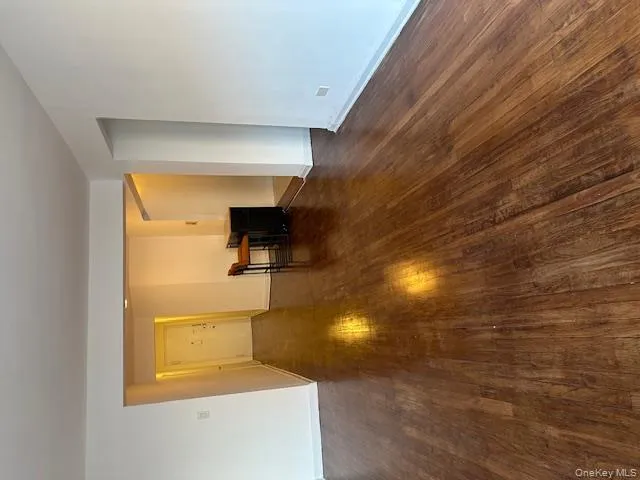 Unfurnished room with dark wood finished floors and baseboards Unfurnished room with dark wood finished floors and baseboards