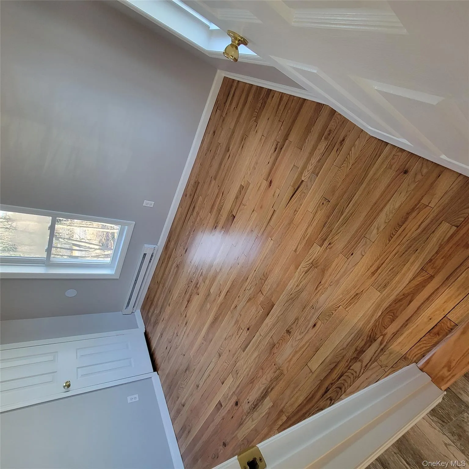 Unfurnished bedroom featuring light wood-type flooring, baseboard heating, and a closet Unfurnished bedroom featuring light wood-type flooring, baseboard heating, and a closet