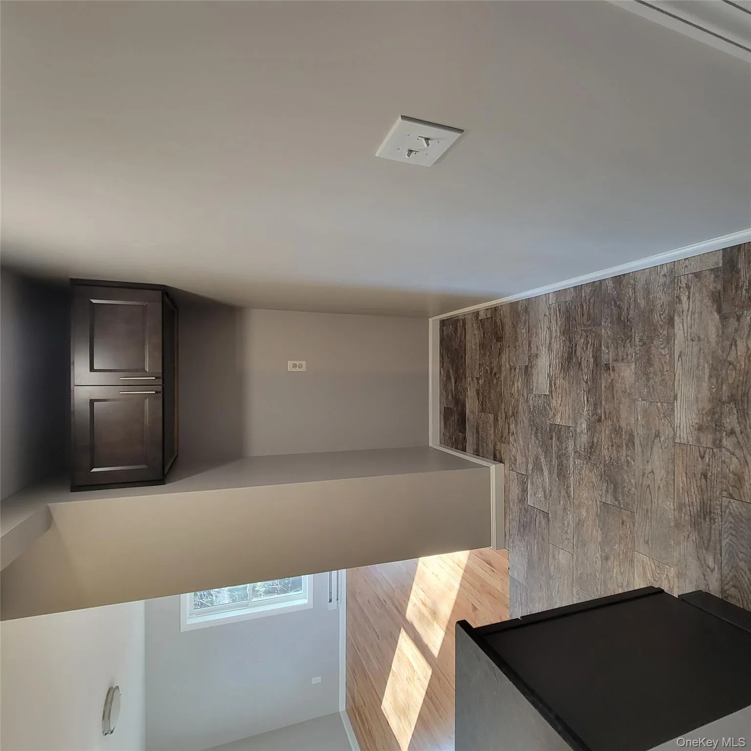 Corridor featuring baseboards and light wood-style flooring Corridor featuring baseboards and light wood-style flooring