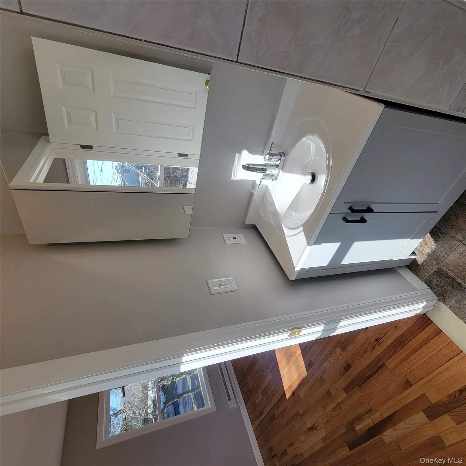 Bathroom featuring vanity, a baseboard radiator, and healthy amount of natural light Bathroom featuring vanity, a baseboard radiator, and healthy amount of natural light