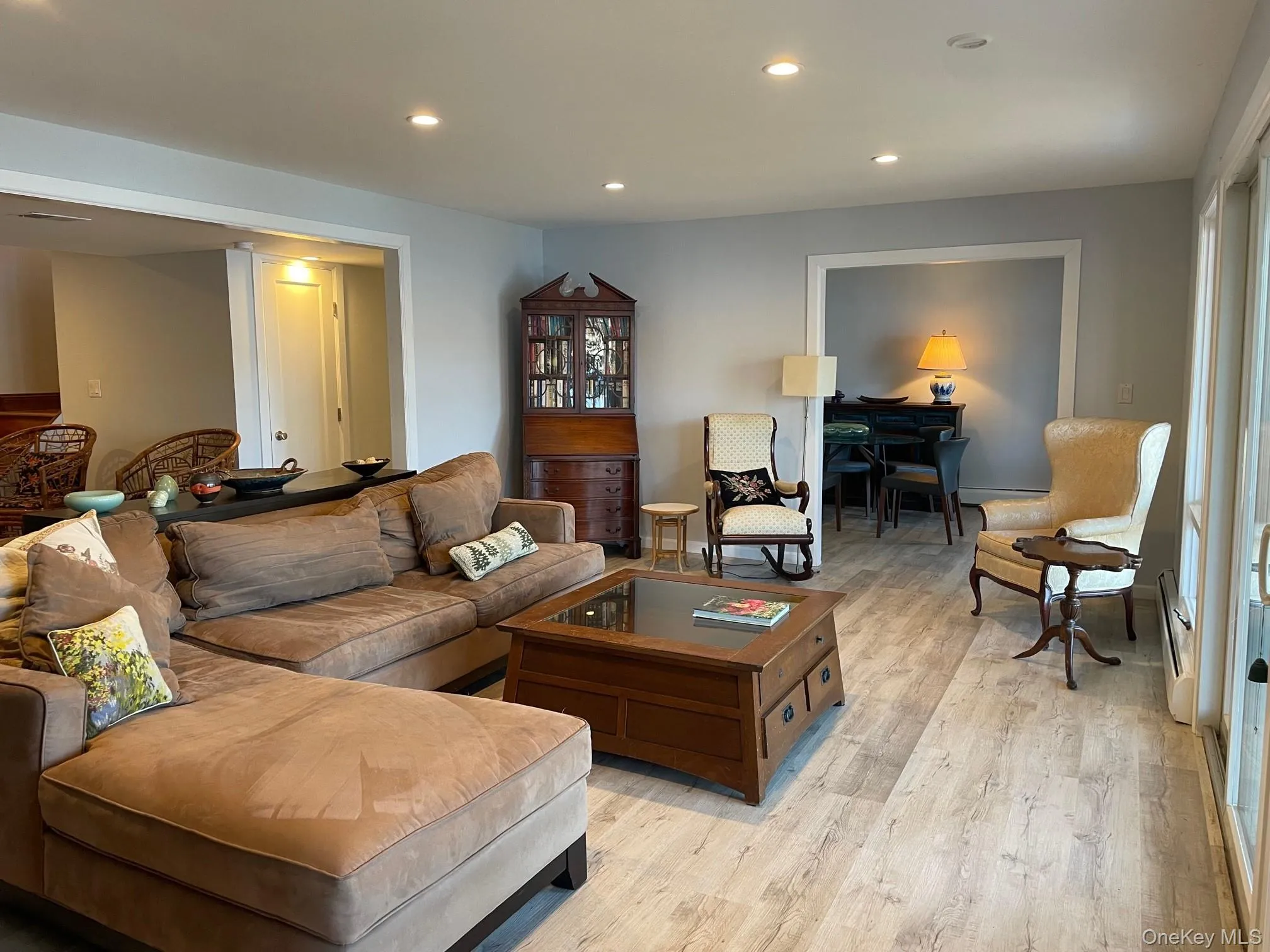 Living room featuring recessed lighting, light wood-style floors, a baseboard radiator, and baseboard heating Living room featuring recessed lighting, light wood-style floors, a baseboard radiator, and baseboard heating