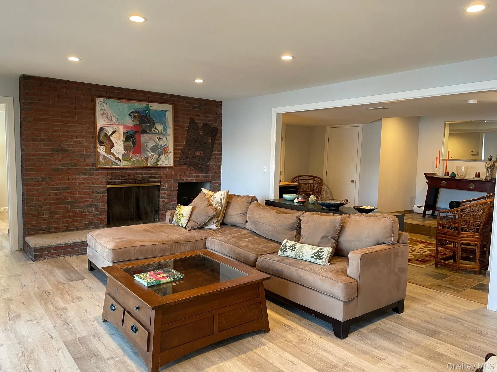 Living room featuring a fireplace, light wood-style floors, and recessed lighting Living room featuring a fireplace, light wood-style floors, and recessed lighting