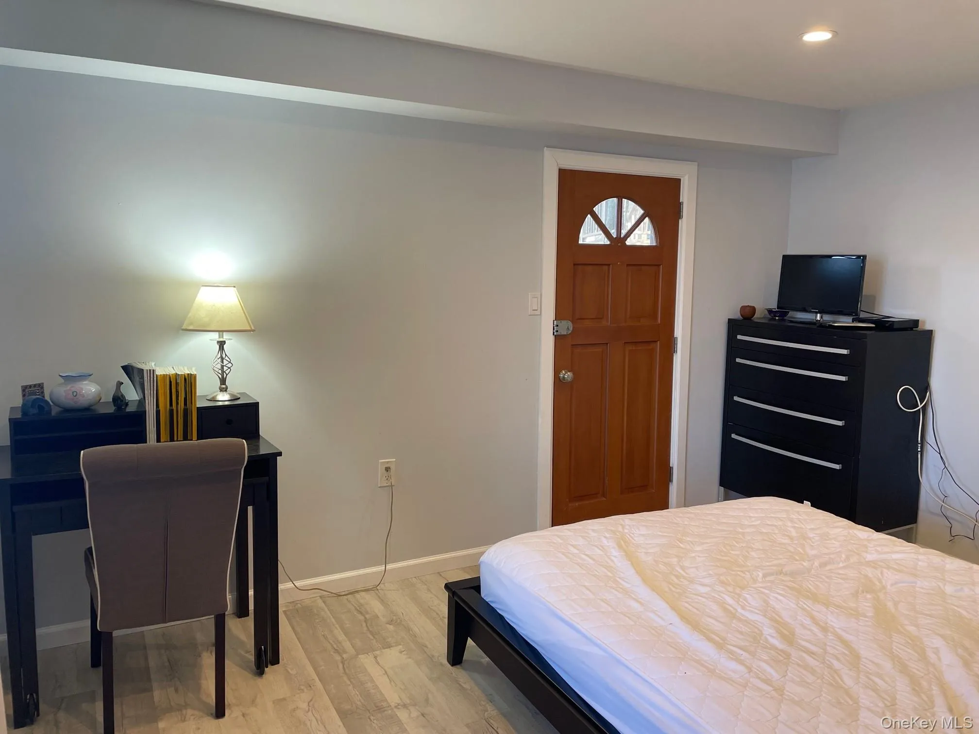 Bedroom featuring light wood-style floors and recessed lighting Bedroom featuring light wood-style floors and recessed lighting