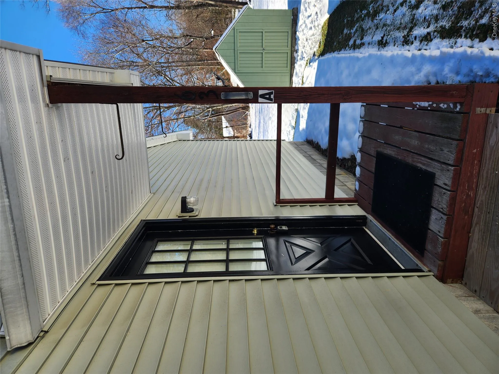 Snow covered property entrance with a porch Snow covered property entrance with a porch