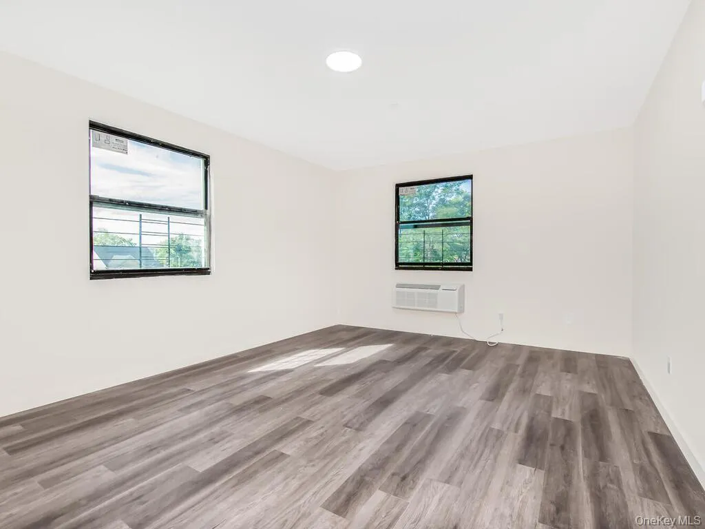 Unfurnished room with wood finished floors and recessed lighting Unfurnished room with wood finished floors and recessed lighting