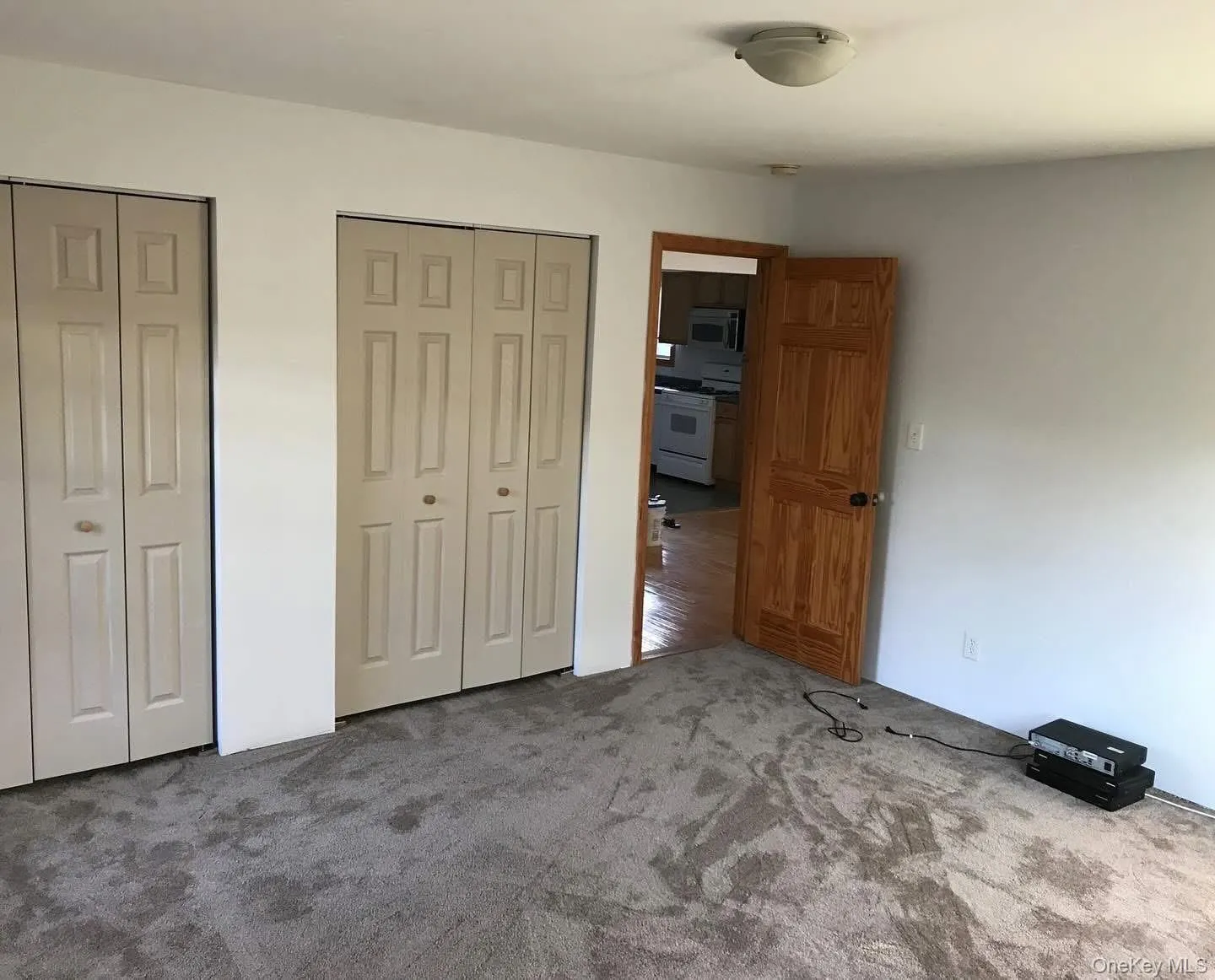 Unfurnished bedroom with two closets and carpet floors Unfurnished bedroom with two closets and carpet floors