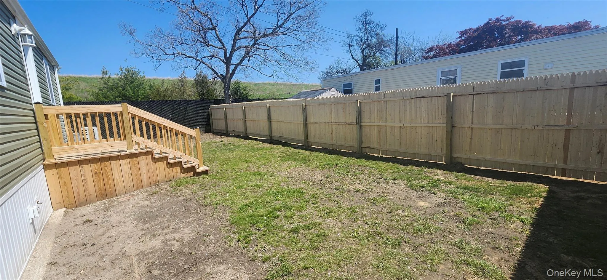View of Side and Backyard of home featuring New Roof, New Siding , New Windows, New Steps and a New Fence View of Side and Backyard of home featuring New Roof, New Siding , New Windows, New Steps and a New Fence