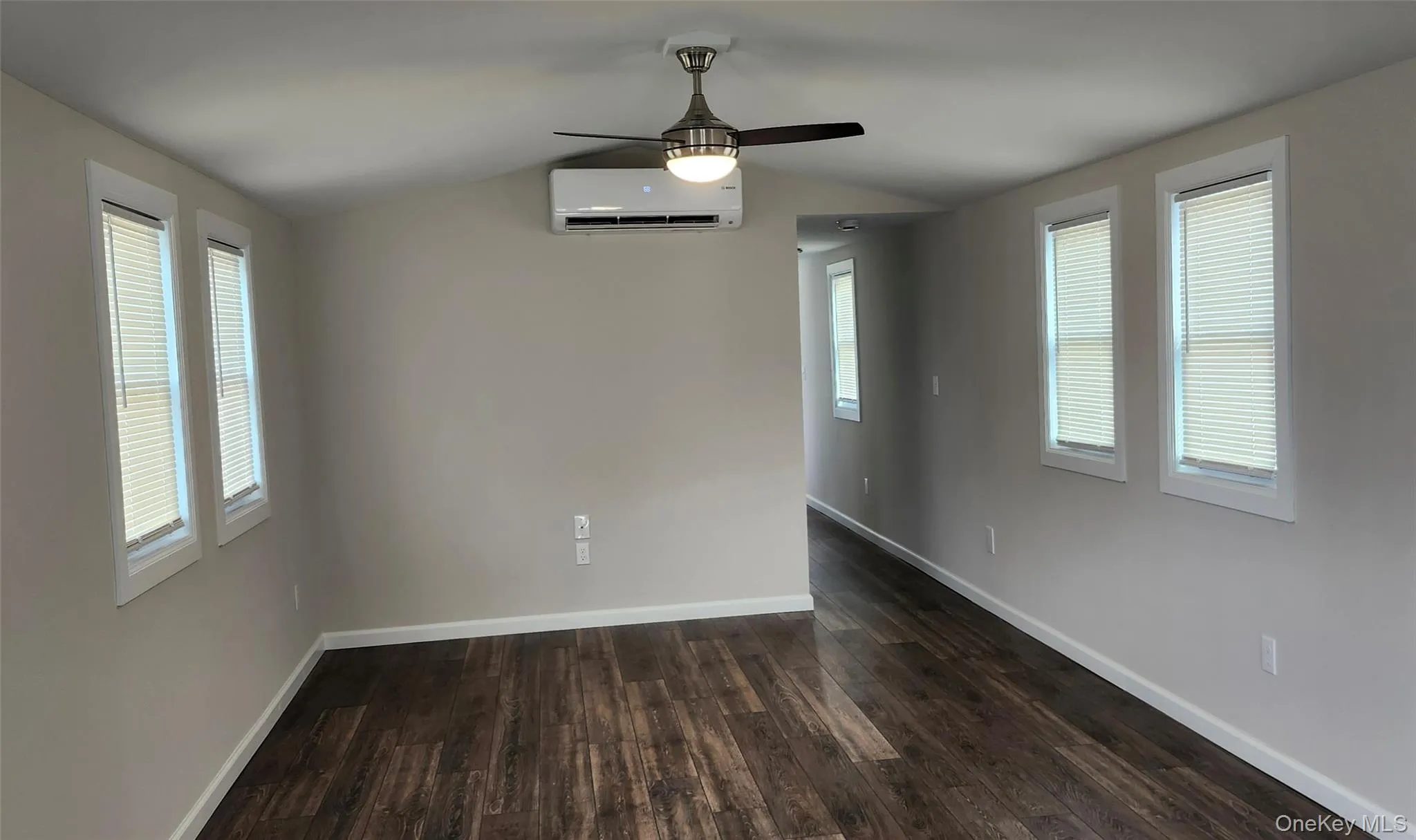 Living Room with Ceiling fan. New Vinyl flooring and ductless Heating/AC system Living Room with Ceiling fan. New Vinyl flooring and ductless Heating/AC system