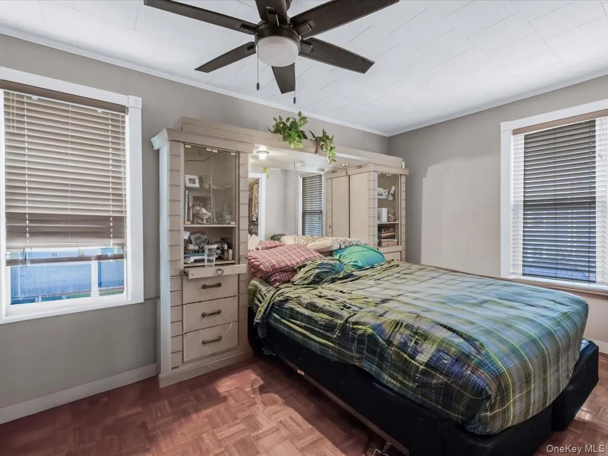 Bedroom with a ceiling fan and ornamental molding Bedroom with a ceiling fan and ornamental molding