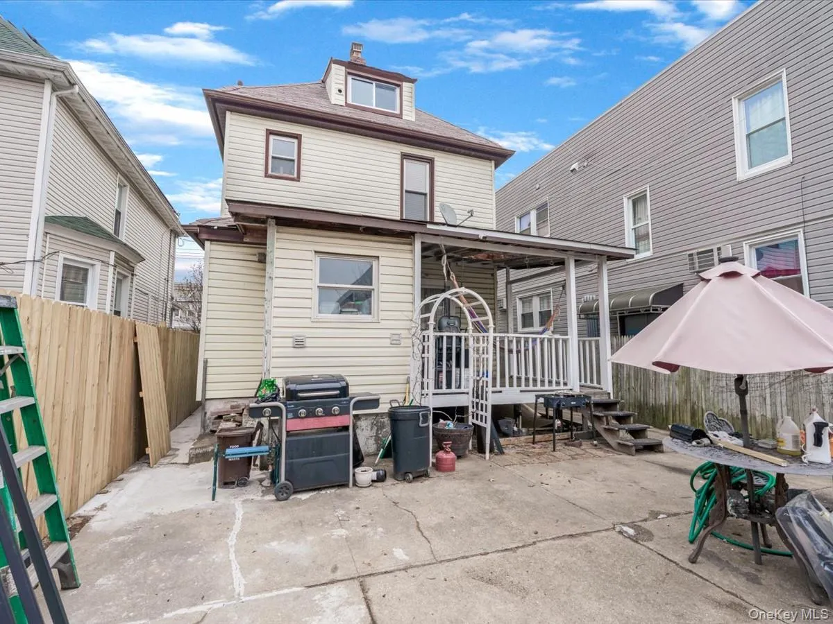 Rear view of house with a patio area and a chimney Rear view of house with a patio area and a chimney