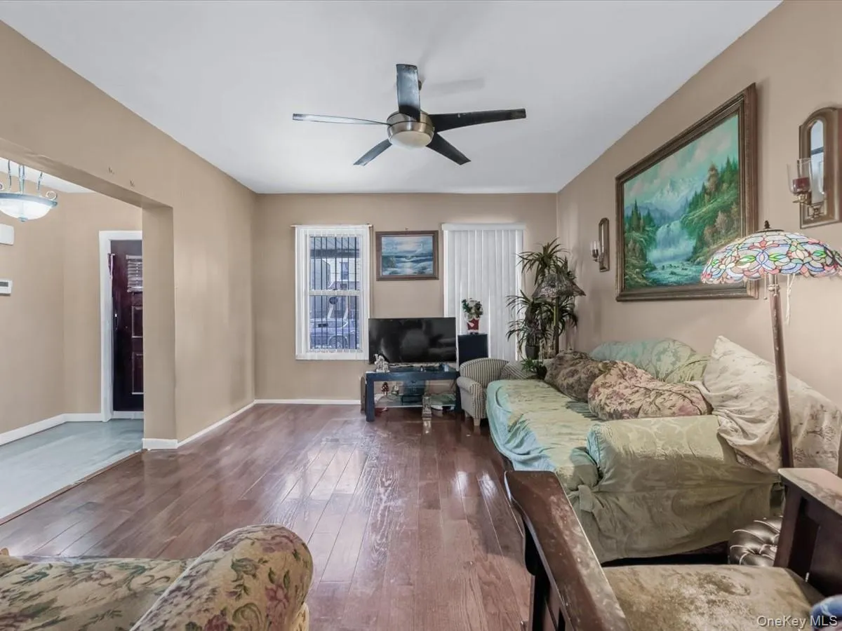 Living room featuring hardwood / wood-style floors and ceiling fan Living room featuring hardwood / wood-style floors and ceiling fan