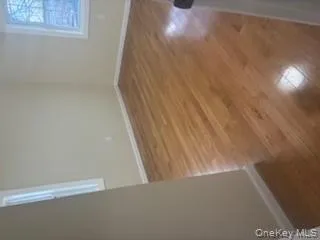 Unfurnished room with baseboards and dark wood-style flooring Unfurnished room with baseboards and dark wood-style flooring