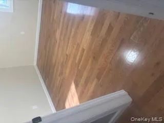 Spare room with dark wood-style floors and baseboards Spare room with dark wood-style floors and baseboards