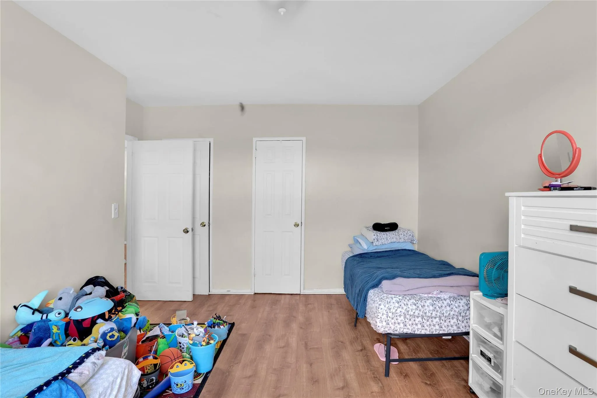 Bedroom featuring light wood finished floors and baseboards Bedroom featuring light wood finished floors and baseboards