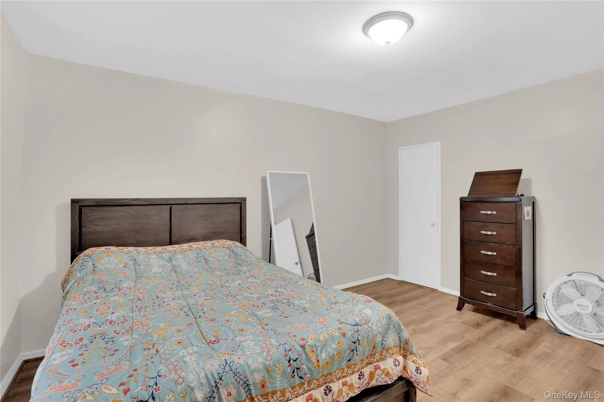 Bedroom with light wood-style flooring Bedroom with light wood-style flooring