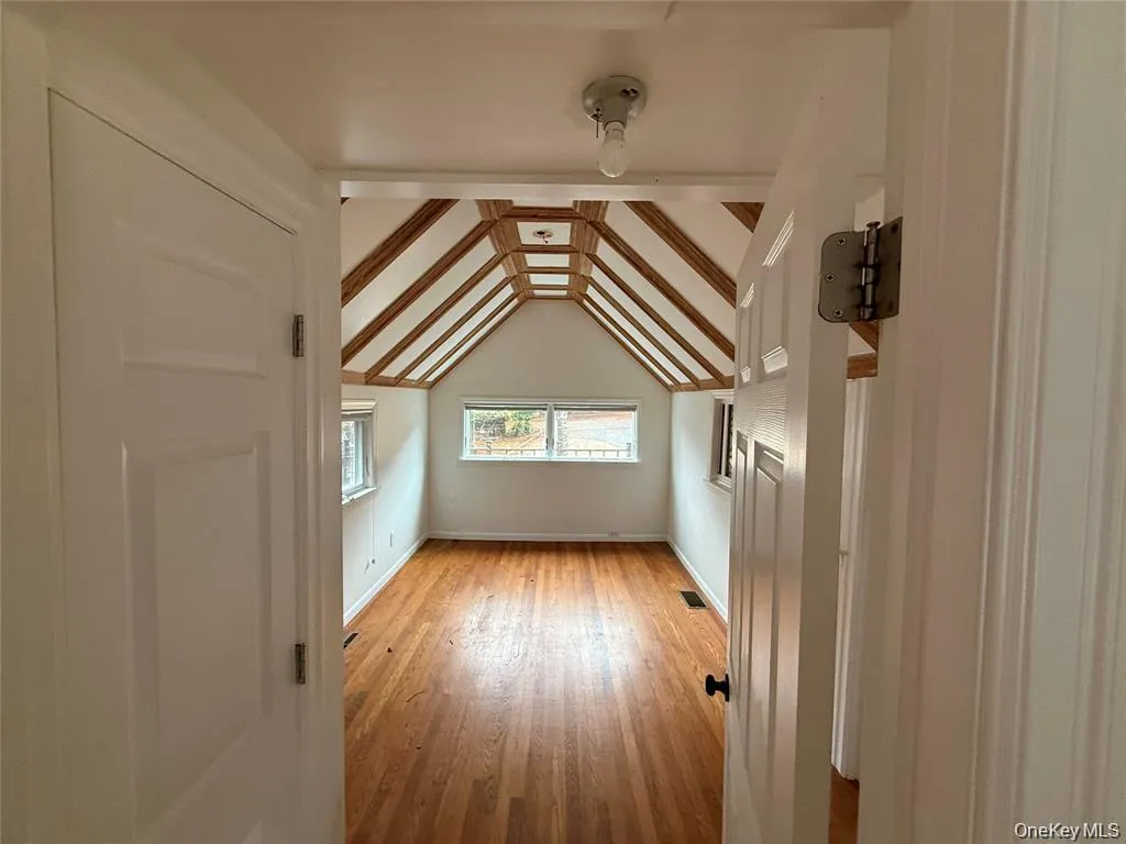 Bonus room featuring light wood-type flooring and baseboards Bonus room featuring light wood-type flooring and baseboards
