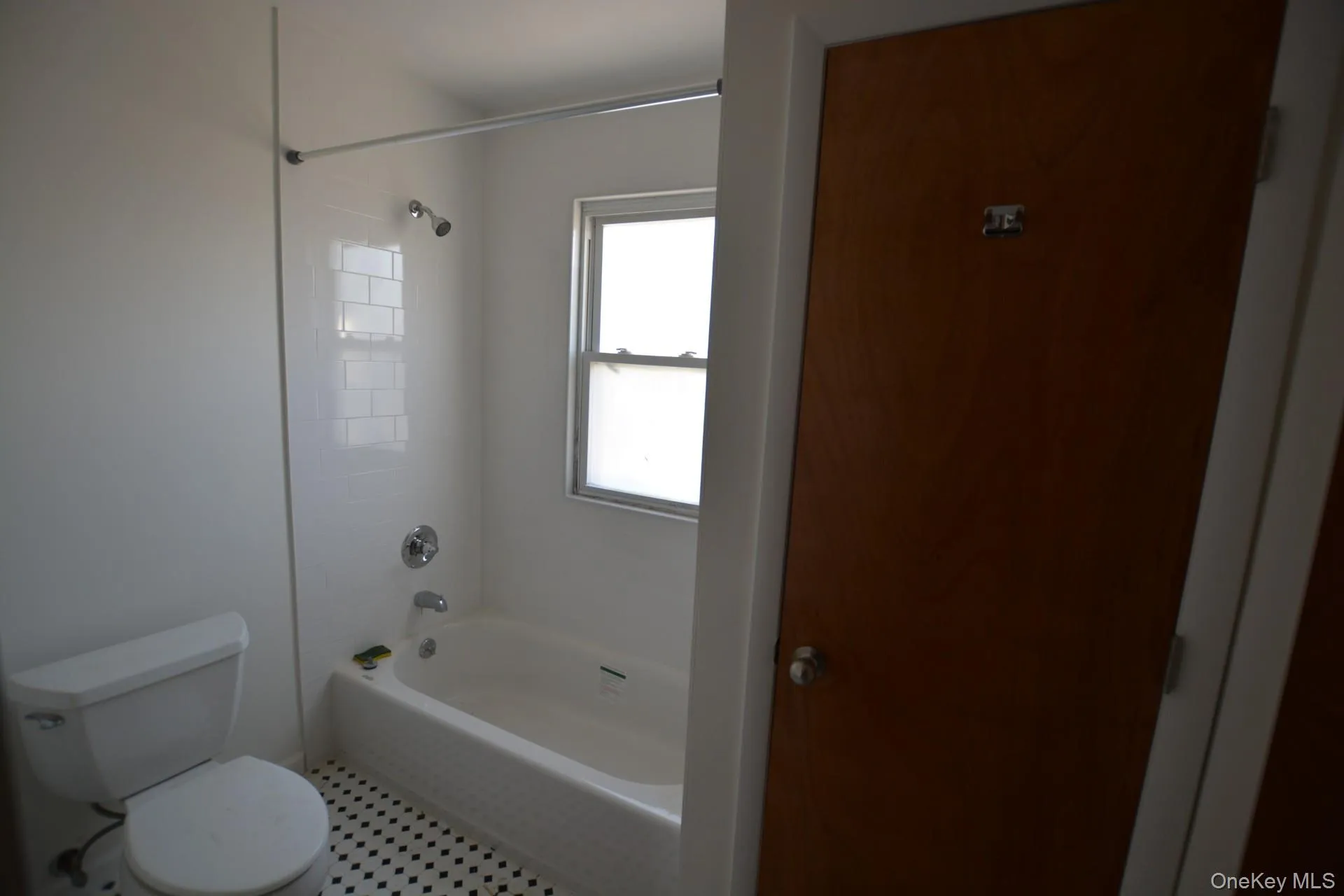 Full bath featuring tub / shower combination and toilet Full bath featuring tub / shower combination and toilet