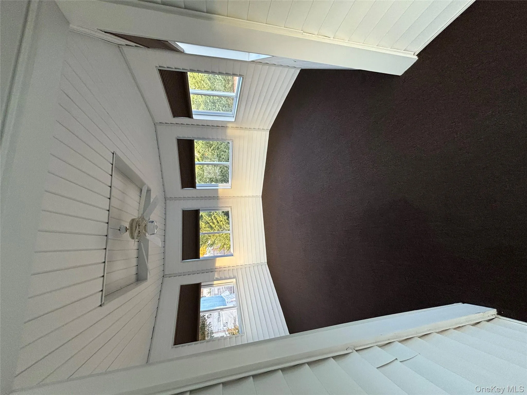 Unfurnished sunroom with wood ceiling and carpet Unfurnished sunroom with wood ceiling and carpet