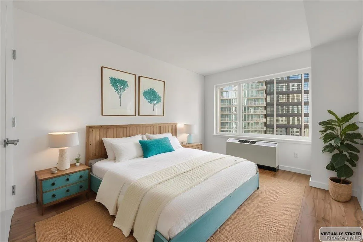 Bedroom featuring wood finished floors and radiator Bedroom featuring wood finished floors and radiator