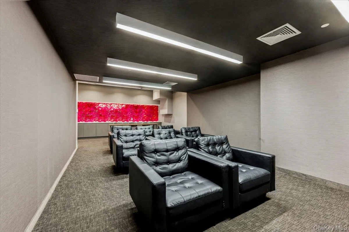 Carpeted cinema room with a textured wall Carpeted cinema room with a textured wall